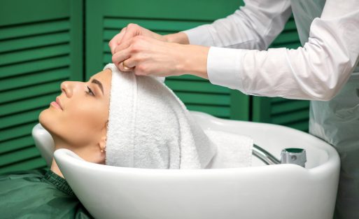 hairdresser-is-wrapping-female-head-towel-after-washing-hair-beauty-salon